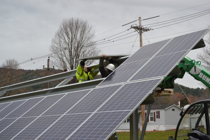 Communities powered by solar workers install panels