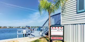 Name Precedes Central Florida Home Retailer Four Star Homes waterfront sign