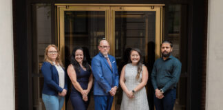 21st Mortgage Expands Community Lending Program Manufactured home community lending 21st mortgage cash management team standing in hq entrance