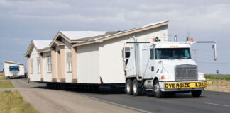 Holding Firm manufactured home transport mover home on road the firm