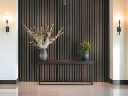 Work Smarter, Not Harder textured wall vertical accent brown woodsy lighted space plants