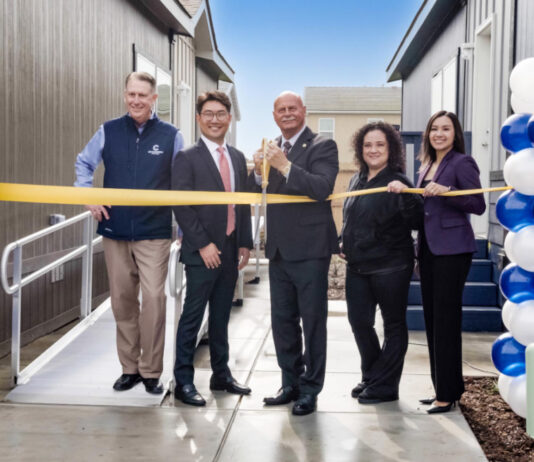 Champion Teams with Developer for Fresno, Calif., Village ribbon cutting between two homes balloons officials fresno manufactured housing attainable build to rent california mhinsider mhvillage