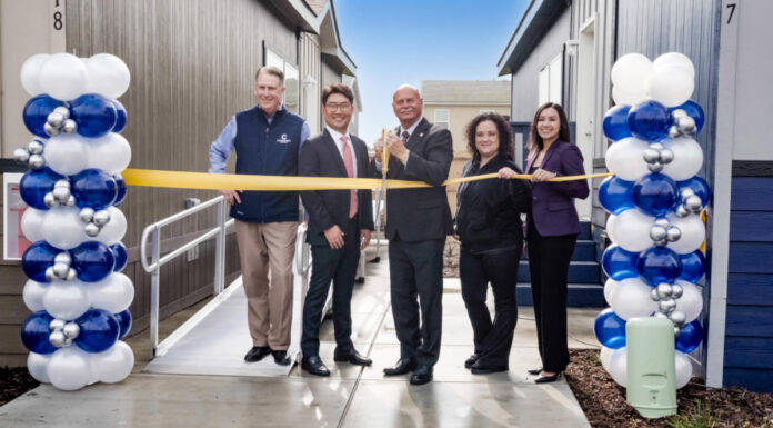 ribbon cutting between two homes balloons officials fresno manufactured housing attainable build to rent california mhinsider mhvillage