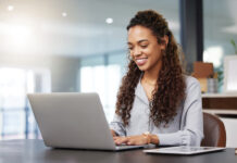 One of Largest Property Management Software Providers Brings MH Manager manufactured housing industry property management software woman at laptop smile productivity