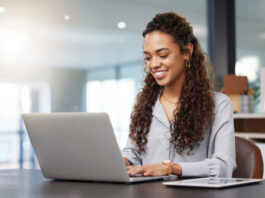 One of the Largest Property Management Software Providers Brings MH Manager manufactured housing industry property management software woman at laptop smile productivity