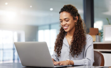 One of Largest Property Management Software Providers Brings MH Manager manufactured housing industry property management software woman at laptop smile productivity
